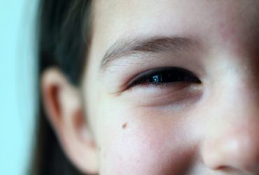 Delightful close-up of a young girl smiling, evoking happiness and innocence.